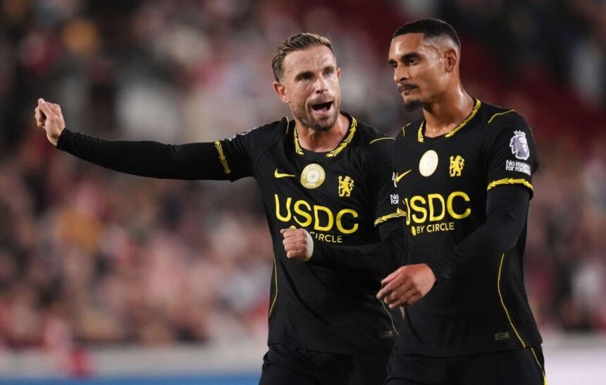 Chelseas Jordan Henderson left gestures and shouts while directing play alongside teammate Maxence Lacroix Both players wear Chelseas black away kit with yellow USDC by Circle sponsorship during the Premier League match at the Gtech Community Stadium in Brentford on September 18 2026  trybalnews