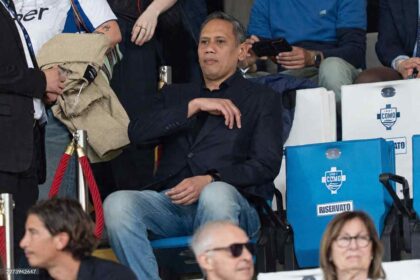 Mirwan Suwarso, President of Como 1907, sits in the stands wearing a dark blazer and jeans during the Serie A Enilive match between Como 1907 and SSC Napoli at Stadio Giuseppe Sinigaglia in Como, Italy on May 2, 2026.