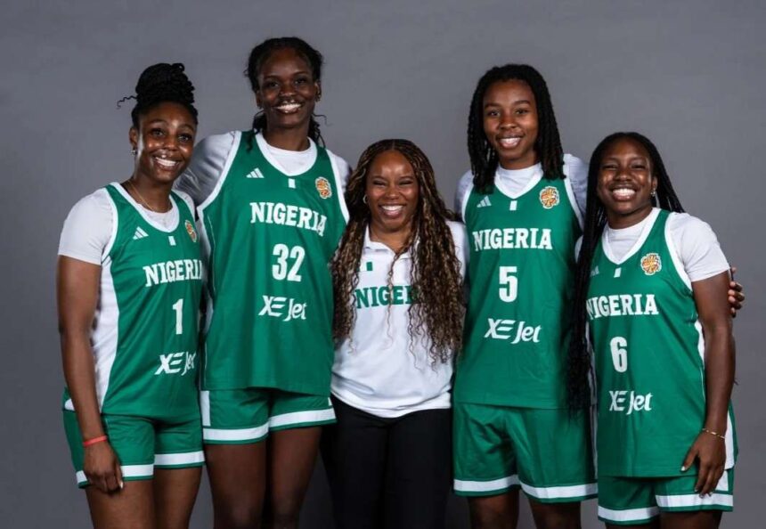 Nigerias womens national basketball team DTigress pose together in green home jerseys with NIGERIA and XE Jet on the front Players wear jersey numbers 1 32 5 and 6 and stand on either side of Head Coach Rena Wakama who is in a white Nigeria polo and black pants The team smiles in front of a plain grey backdrop  trybalnews