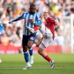 Coventry City midfielder Frank Onyeka wearing number 16 in a blue and white striped shirt challenges Nottingham Forest midfielder Xaver Schlager in a red shirt for possession of the ball during the Premier League match at the City Ground  trybalnews