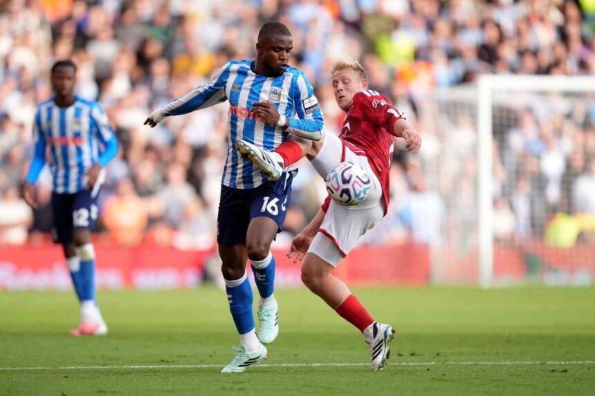 Coventry City midfielder Frank Onyeka wearing number 16 in a blue and white striped shirt challenges Nottingham Forest midfielder Xaver Schlager in a red shirt for possession of the ball during the Premier League match at the City Ground  trybalnews