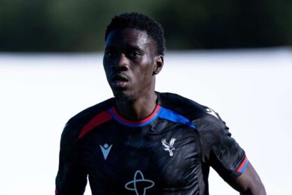 Crystal Palace forward Ismaïla Sarr runs during a pre-season friendly match against Fulham, wearing a black Crystal Palace kit with red and blue trim and "Temporal" sponsor. Photo taken at Motspur Park in London, England on August 7, 2026.