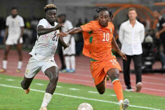 Ivory Coast forward Yan Diomande, wearing number 10, battles Ghana defender Kojo Peprah Oppong for the ball during the 2027 Africa Cup of Nations qualifier between Ivory Coast and Ghana at Stade de Bouake