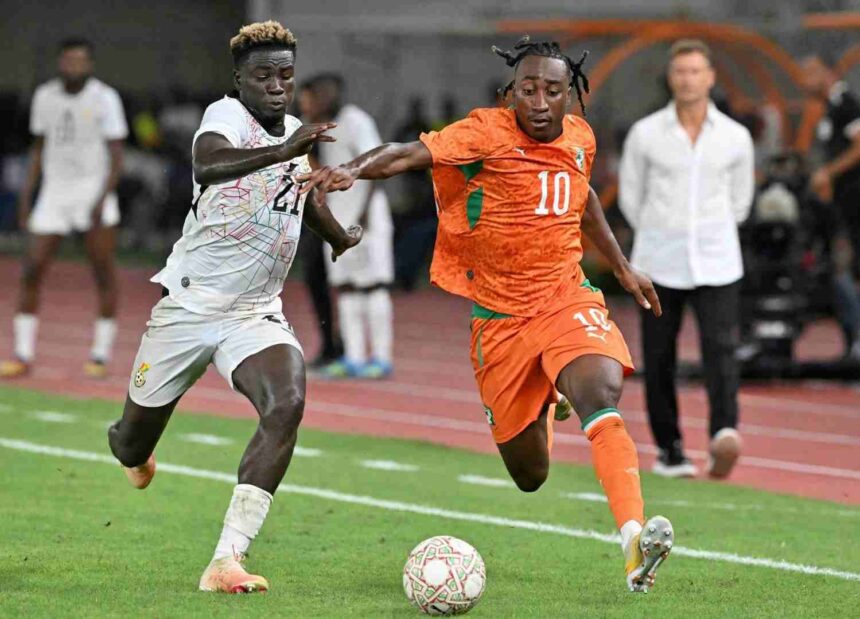 Ivory Coast forward Yan Diomande wearing number 10 battles Ghana defender Kojo Peprah Oppong for the ball during the 2027 Africa Cup of Nations qualifier between Ivory Coast and Ghana at Stade de Bouake  trybalnews