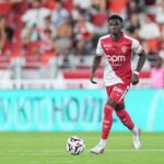 Lamine Camara of AS Monaco wearing a red and white home kit dribbles a football during the Ligue 1 McDonalds match between Monaco and Marseille at Louis II Stadium on August 30 2026 in Monaco Fans in red seats are blurred in the background  trybalnews