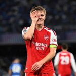 Martin Odegaard captain of Arsenal FC celebrates wearing a red home jersey and green captains armband during the UEFA Champions League 202627 League Phase match between SSC Napoli and Arsenal FC at Stadio Diego Armando Maradona in Naples Italy on September 9 2026  trybalnews