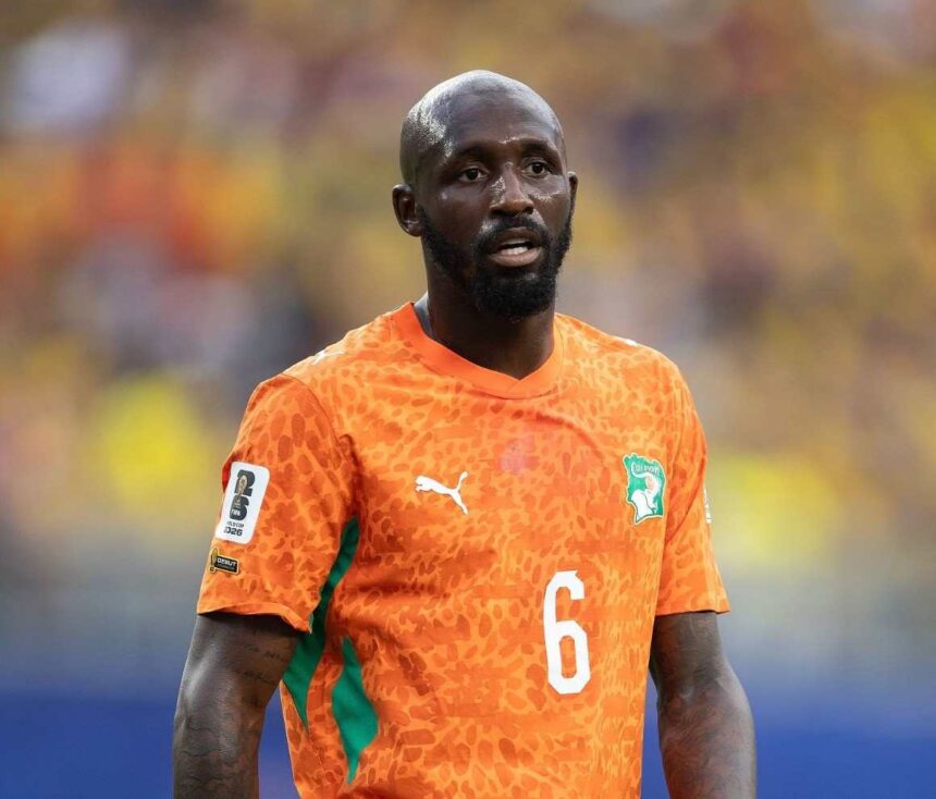 Close up of Seko Fofana of Cote dIvoire wearing an orange number 6 jersey with green accents during the FIFA World Cup 2026 Group E match between Cote dIvoire and Ecuador at Philadelphia Stadium on June 14 2026 He has a bald head and beard and is looking forward on the pitch with a blurred stadium crowd in the background  trybalnews