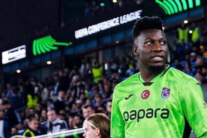 Trabzonspor goalkeeper Andre Onana wearing bright green Papara jersey walking out at Papara Park before UEFA Conference League match against Heart of Midlothian in Trabzon.
