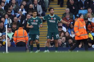 Brightons Yasin Ayari wearing the dark green No 26 kit celebrates with teammate No 19 in front of the crowd after scoring during the Premier League match against Manchester City at the Etihad Stadium  trybalnews
