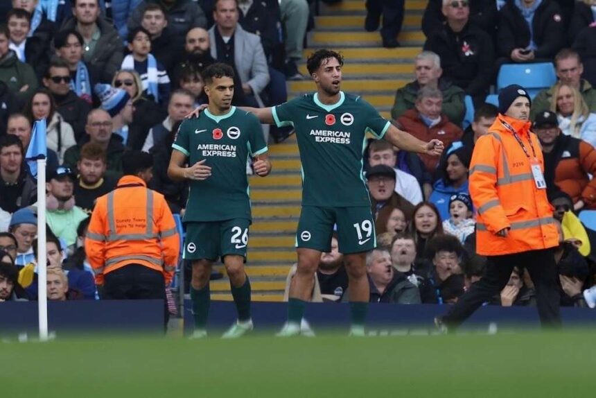 Brightons Yasin Ayari wearing the dark green No 26 kit celebrates with teammate No 19 in front of the crowd after scoring during the Premier League match against Manchester City at the Etihad Stadium  trybalnews