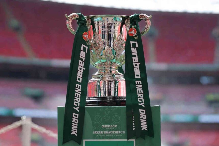 Silver Carabao Cup trophy with green Carabao Energy Drink ribbons on green plinth reading Arsenal v Manchester City Final 2026  trybalnews