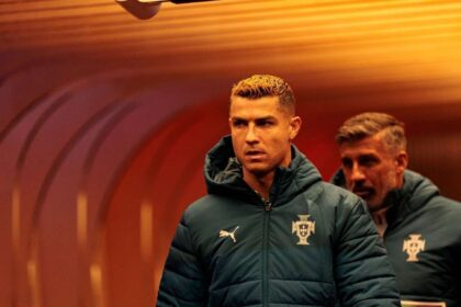 Cristiano Ronaldo of Portugal walks through the tunnel in a dark green Portugal puffer jacket ahead of the UEFA Nations League match against Norway at Ullevaal Stadion in Oslo, Norway.