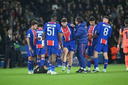 Khvicha Kvaratskhelia of Paris Saint-Germain gets injured and is assisted off the pitch by medical staff during Champions League match against FC Barcelona at Parc des Princes