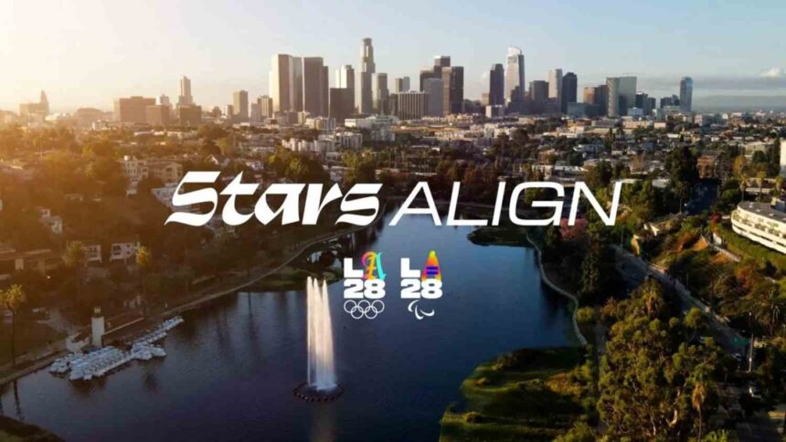 Aerial view of Los Angeles skyline with Echo Park Lake in foreground overlaid with text Stars ALIGN and the LA28 Olympic and Paralympic Games logos  trybalnews