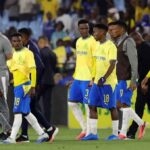 Mamelodi Sundowns players in yellow shirts and blue shorts walking off pitch looking dejected after 1 1 draw with Wiliete SC and CAF Champions League elimination at Loftus Versfeld Stadium  trybalnews