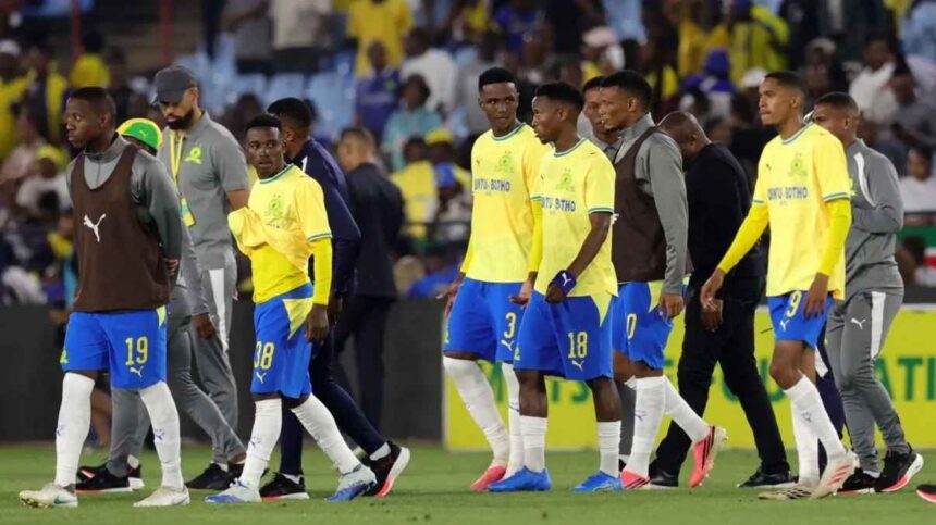 Mamelodi Sundowns players in yellow shirts and blue shorts walking off pitch looking dejected after 1 1 draw with Wiliete SC and CAF Champions League elimination at Loftus Versfeld Stadium  trybalnews