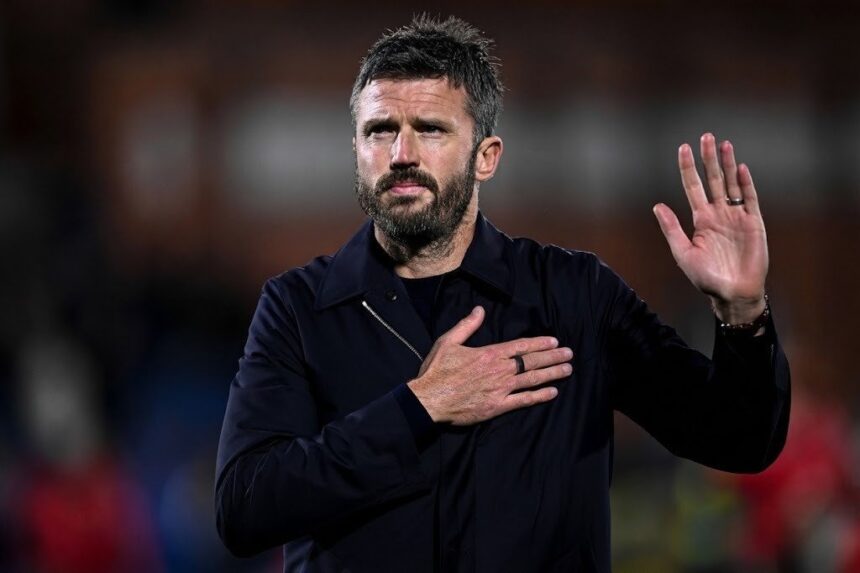Michael Carrick wearing black jacket with hand on chest and other hand raised apologising to Manchester United supporters after 4 1 Champions League loss to Como 1907 at Giuseppe Sinigaglia Stadium  trybalnews