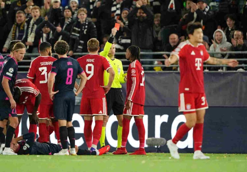 Michael Olise of FC Bayern Munich wearing the red Bayern kit with dreadlocks receives a red card from the referee during the UEFA Champions League 202627 League Phase MD2 match between Viking FK and FC Bayern Munich at Viking Stadion on October 13 2026 in Stavanger Norway Teammates including Harry Kane number 9 look on as a Viking FK player lies injured on the pitch  trybalnews