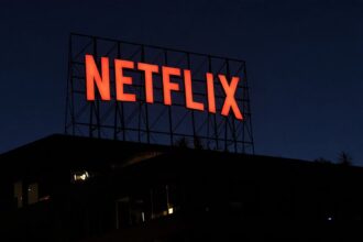 The illuminated Netflix logo in bright red letters on a large rooftop sign structure at night on top of an office building in Los Angeles California on May 29 2026  trybalnews