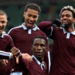 Four Aston Villa players in claret shirts celebrating a goal with Nicolas Jackson in front pointing down teammates smiling and cheering behind him during Premier League match at Villa Park  trybalnews