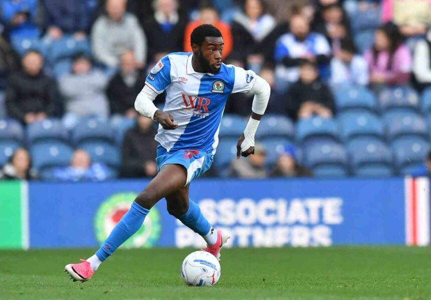 Ryan Alebiosu of Blackburn Rovers in blue and white halved kit dribbling ball on pitch wearing pink boots and white wrist bandage during Championship match at Ewood Park  trybalnews