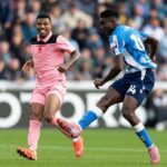 Coventry City striker Taiwo Awoniyi wearing the blue and white striped No 14 shirt takes a shot past a Sunderland defender in pink during the Premier League match at the Coventry Building Society Arena  trybalnews