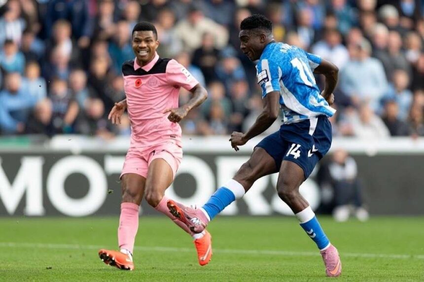 Coventry City striker Taiwo Awoniyi wearing the blue and white striped No 14 shirt takes a shot past a Sunderland defender in pink during the Premier League match at the Coventry Building Society Arena  trybalnews