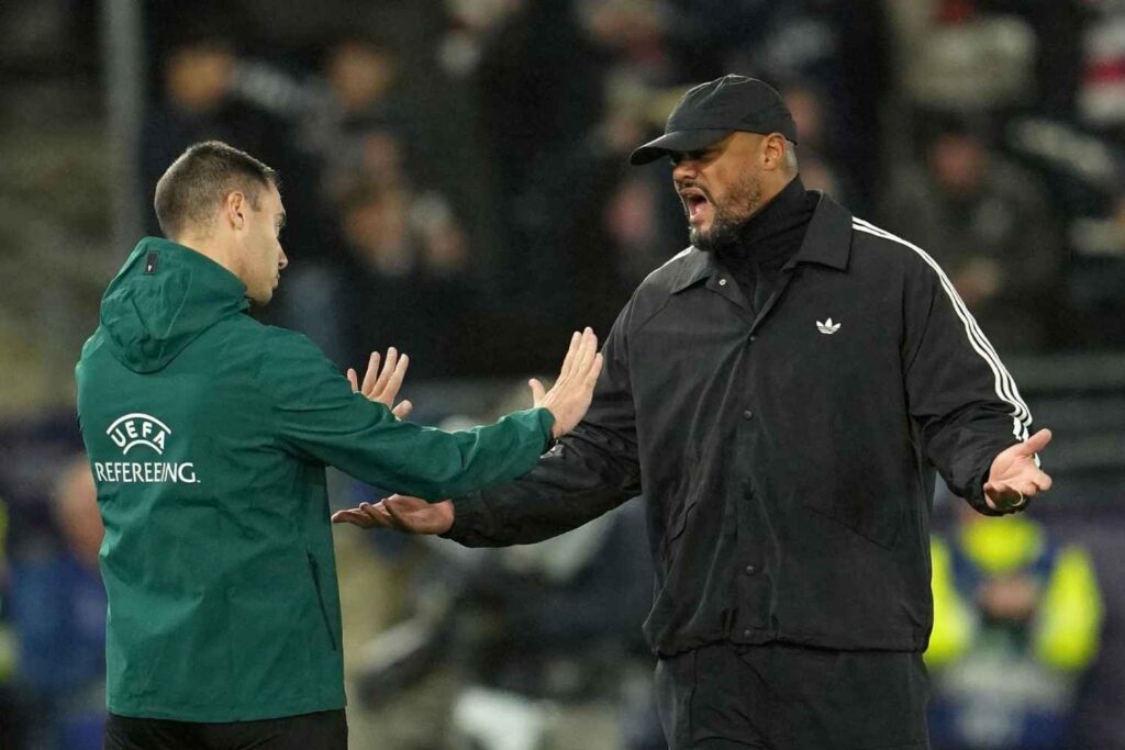 Vincent Kompany Trybal News Vincent Kompany manager of FC Bayern Munich wearing a black Adidas jacket and black cap reacts animatedly and argues on the touchline with a UEFA refereeing official in a green jacket during the UEFA Champions League 202627 League Phase MD2 match between Viking FK and FC Bayern Munich at Viking Stadion on October 13 2026 in Stavanger Norway trybalnews
